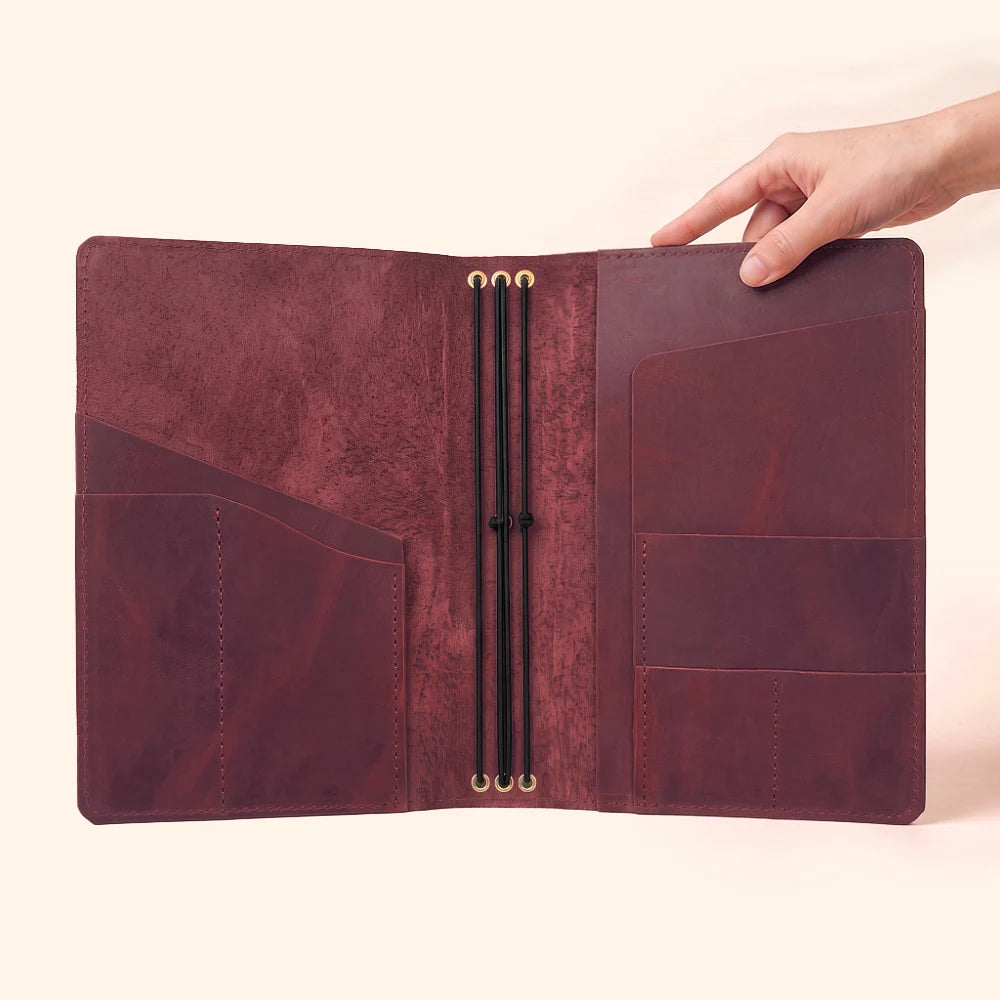 Handmade leather organizer offering a secure home for three interchangeable inserts.