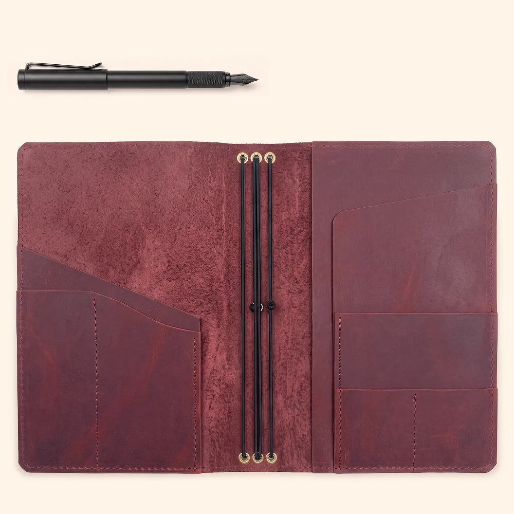Leather refill cover with internal elastic cords for arranging three notebook sections.
