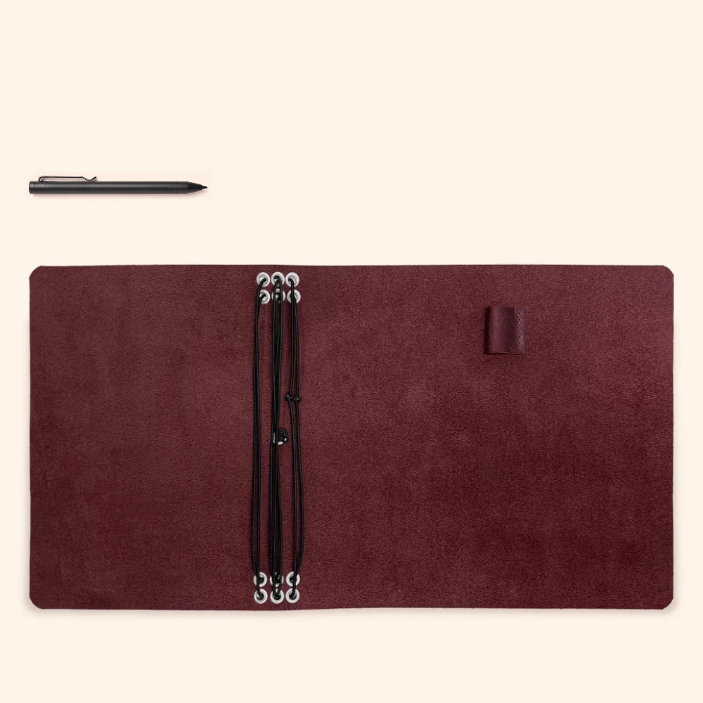 Refillable leather organizer designed to keep six slim notebook refills together.