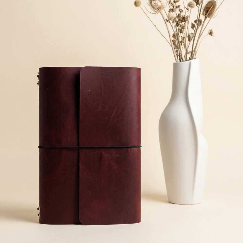 Natural leather notebook organizer with six elastic straps for interchangeable inserts.