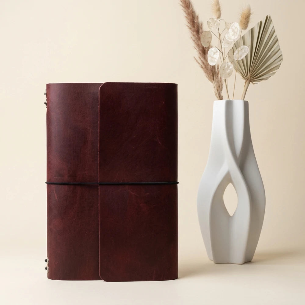 Classic leather notebook holder with six elastic bands and a secure pen loop.