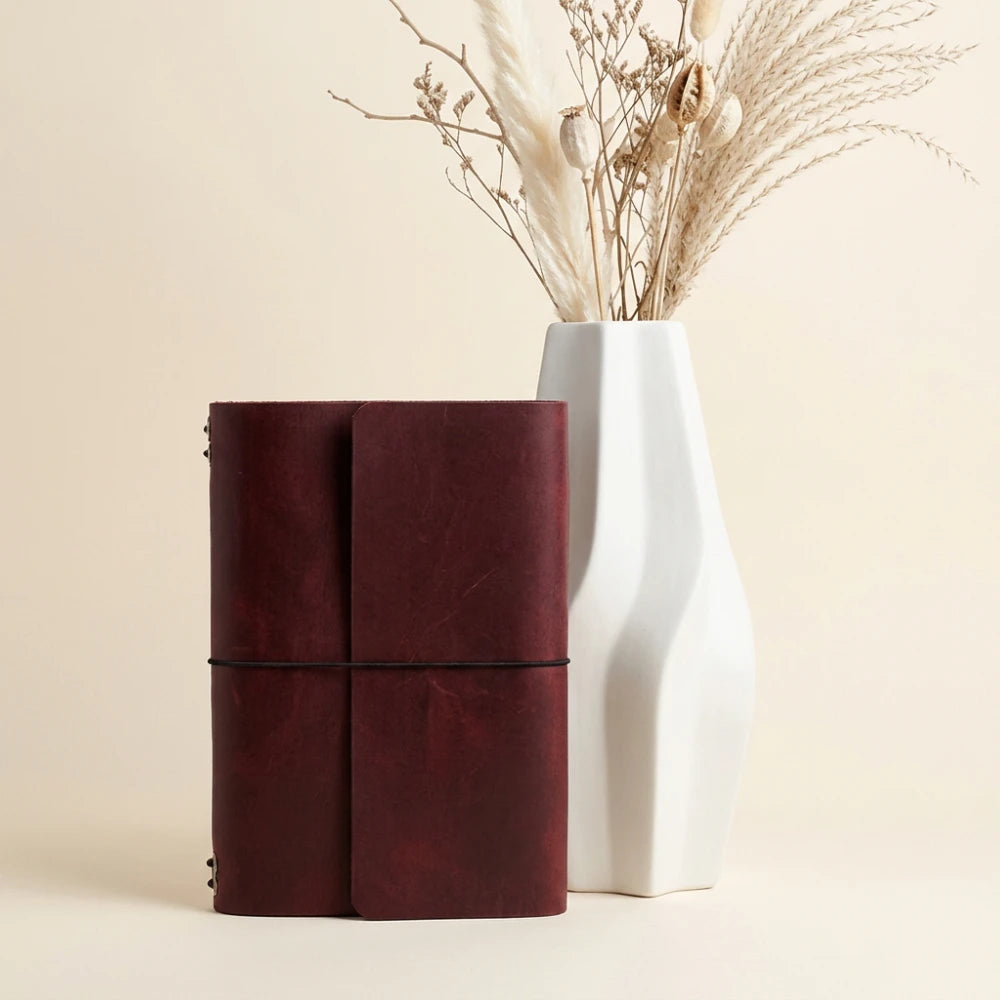 Premium leather planner cover with six elastic straps and an attached pen holder.