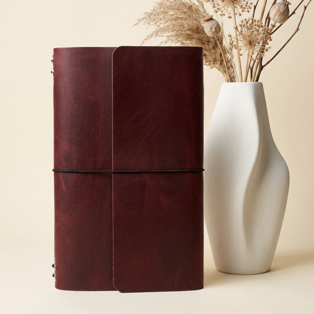Genuine leather notebook wallet built for carrying six replaceable inserts and a pen.