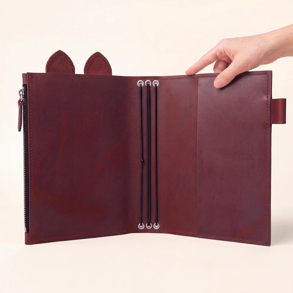Handmade planner organizer with playful ear-shaped details and functional storage sections.