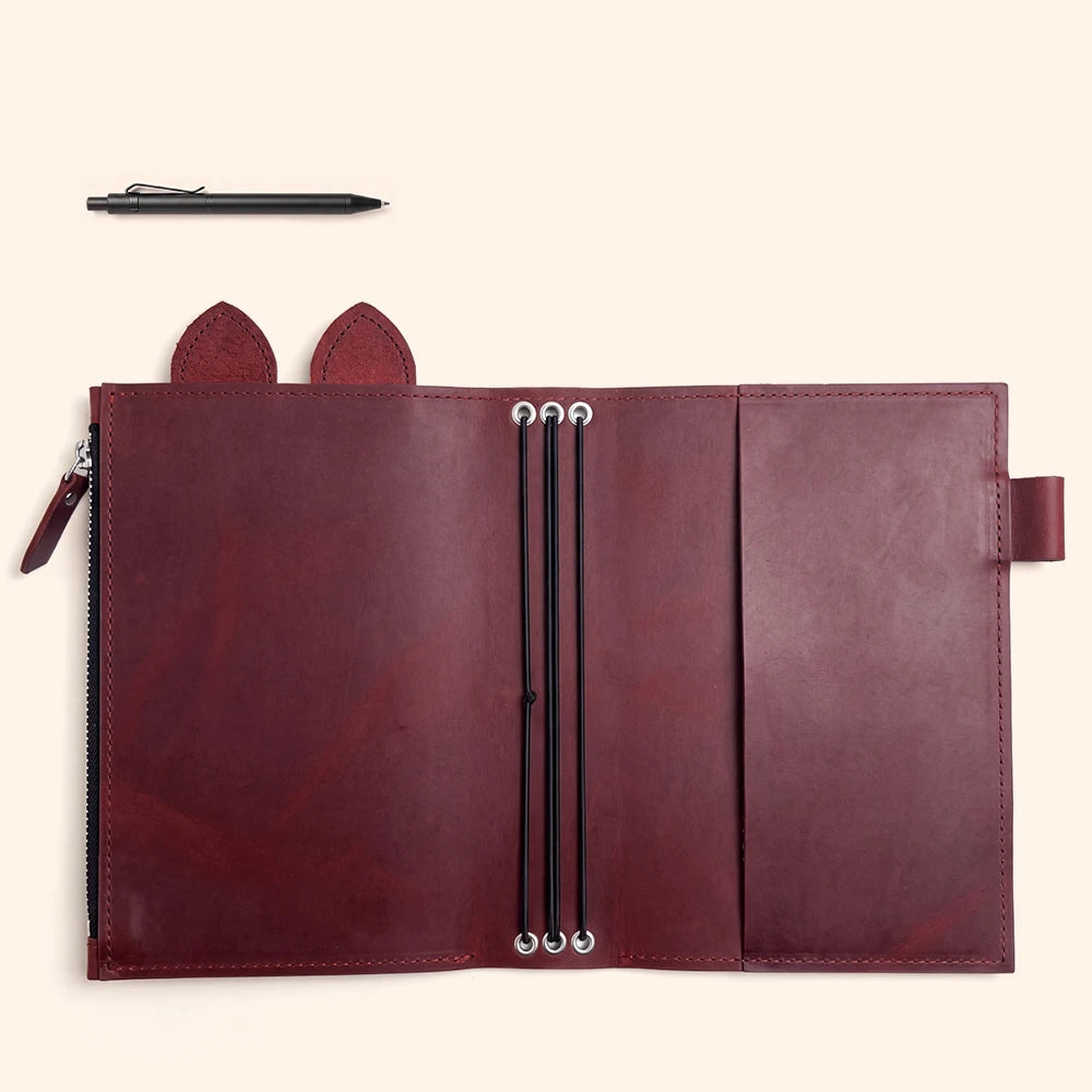 Handmade genuine leather cover with detailed stitching and a built-in pen holder.