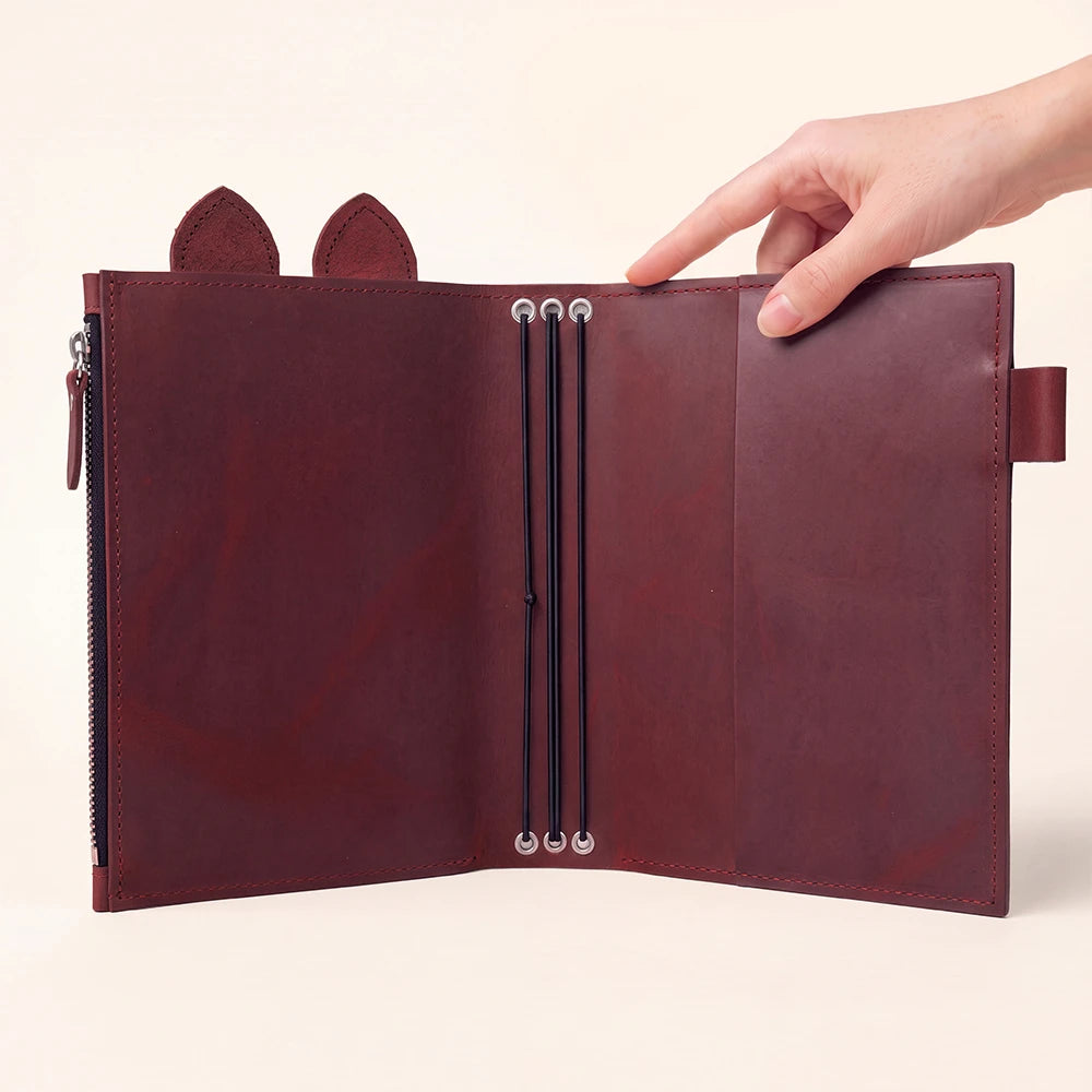Handmade journal organizer featuring a large zippered compartment for storing small essentials.