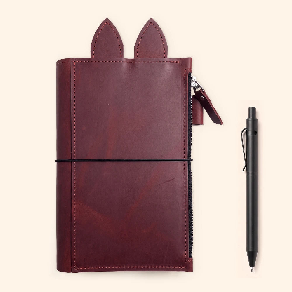 Genuine leather notebook case combining practical storage with whimsical decorative ear tabs.