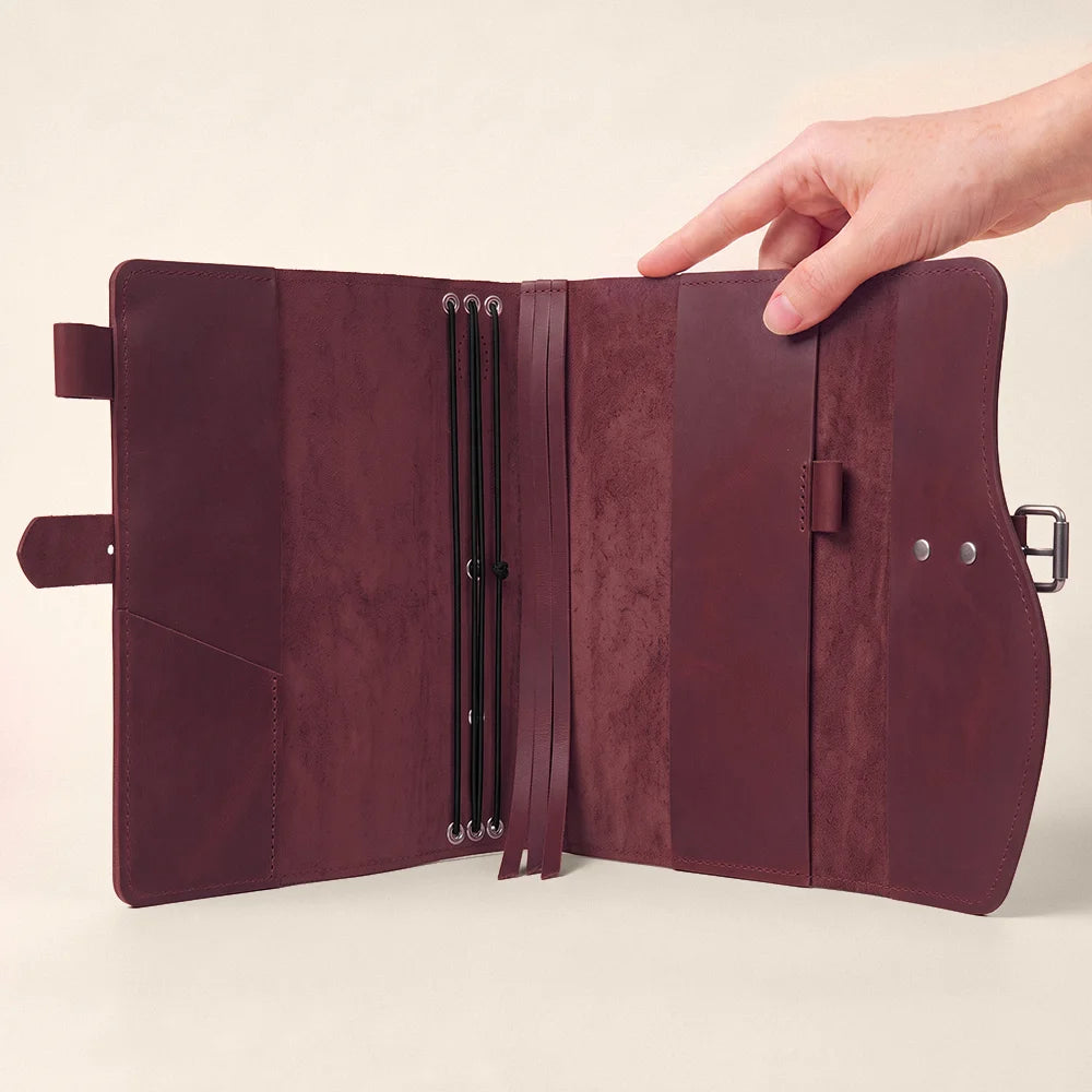 Classic leather journal cover showing organized pockets, pen keeper, built-in page marker, and exterior handle.