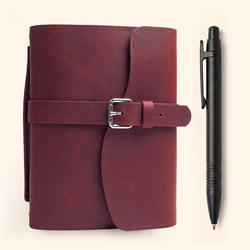Genuine leather journal organizer showing interior compartments, pen loop, built-in bookmark, and convenient external handle.