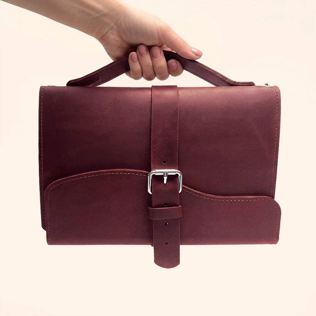 Premium leather cover for travel notebooks with triple elastic bands and carry handle.
