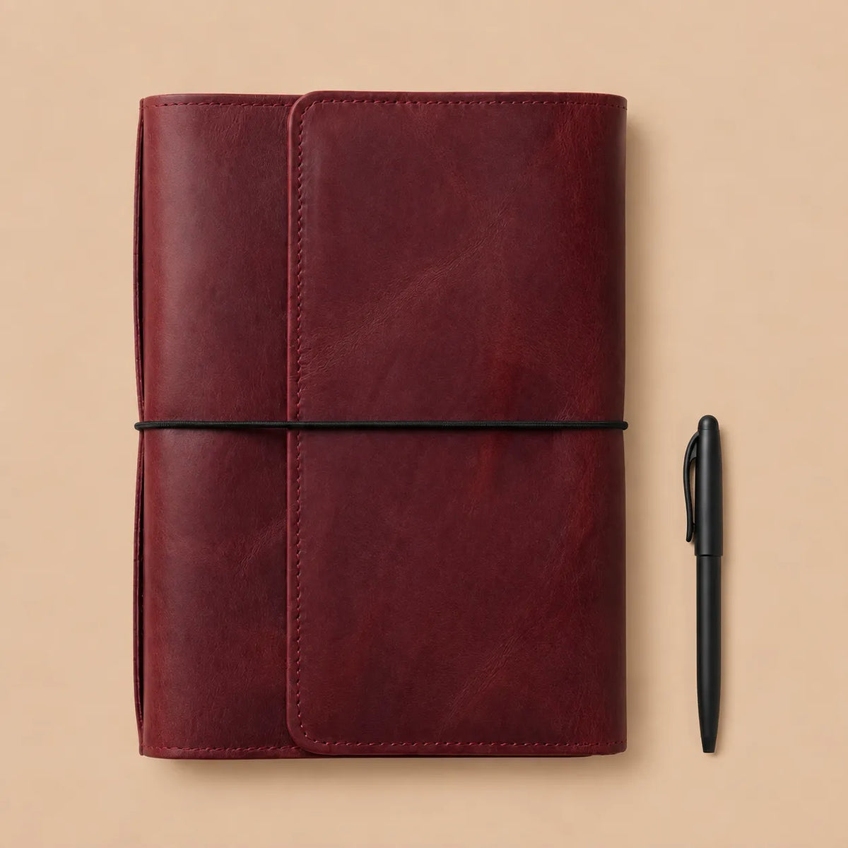 Genuine leather journal cover in rich burgundy with six elastic straps and interior organization.