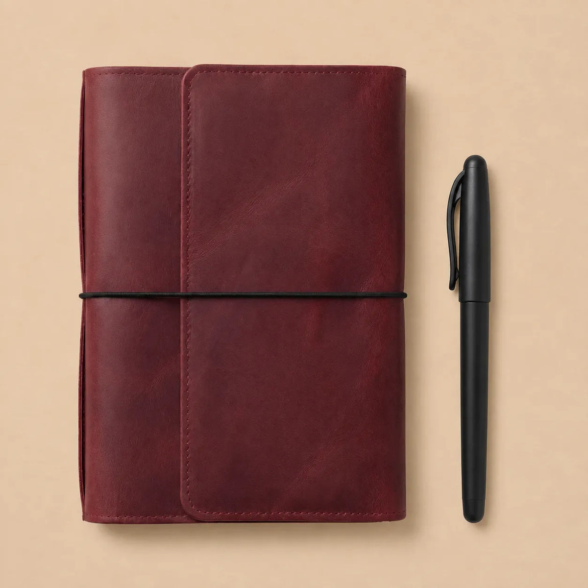 Handmade burgundy notebook cover crafted from genuine leather with six elastic bands and pockets.