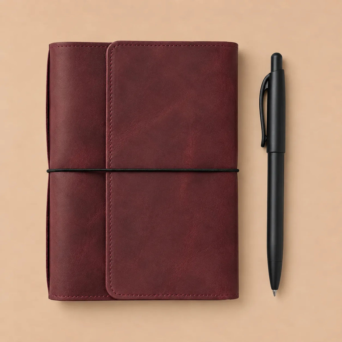 Elegant burgundy genuine leather notebook cover with six elastics, pockets, zipper storage, and pen holder.