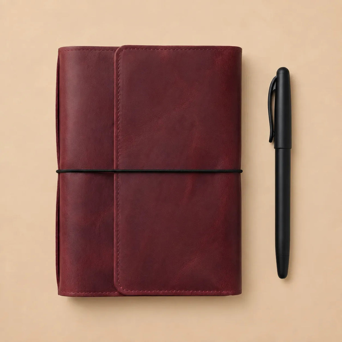 Burgundy leather planner cover with six elastic bands, interior pockets, zippered pocket, and pen loop.