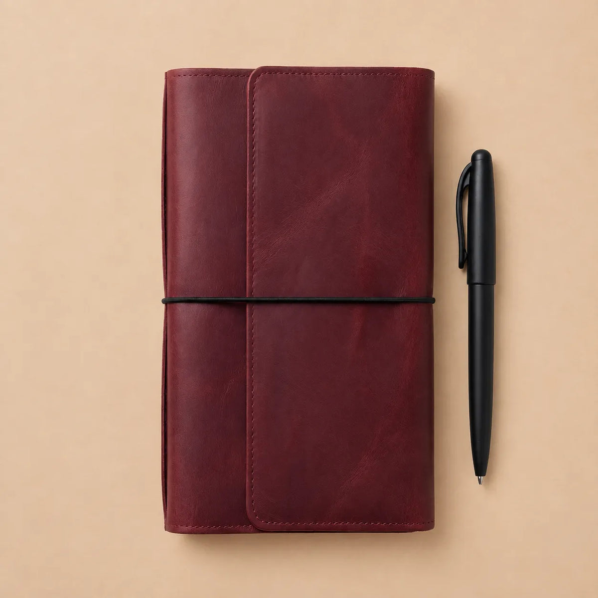 Premium burgundy leather notebook cover with six elastic bands, pockets, large zipper pocket, and pen holder.