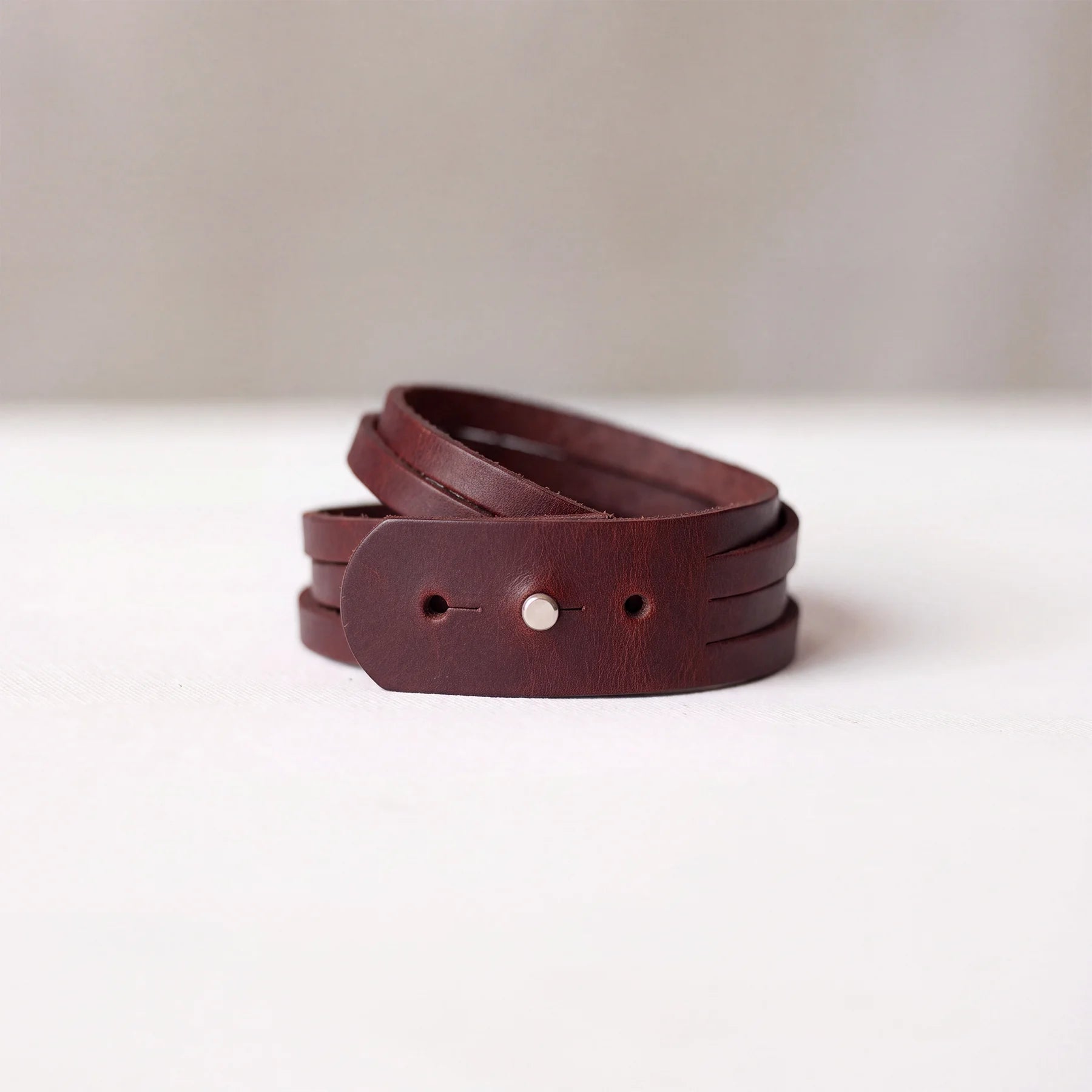 Genuine leather wristband with snap button fastening, perfect for casual everyday outfits.