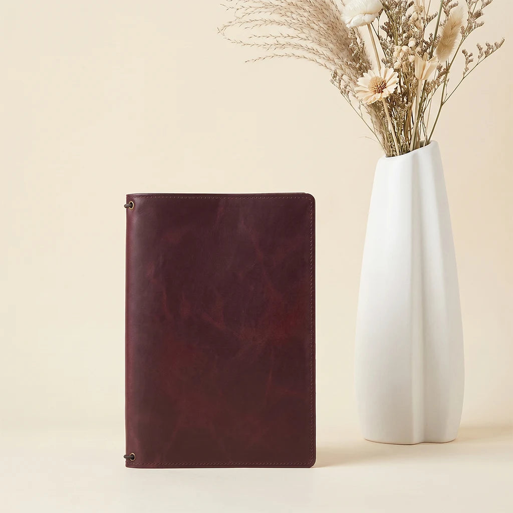 Leather planner cover featuring spacious compartments for papers and cards.