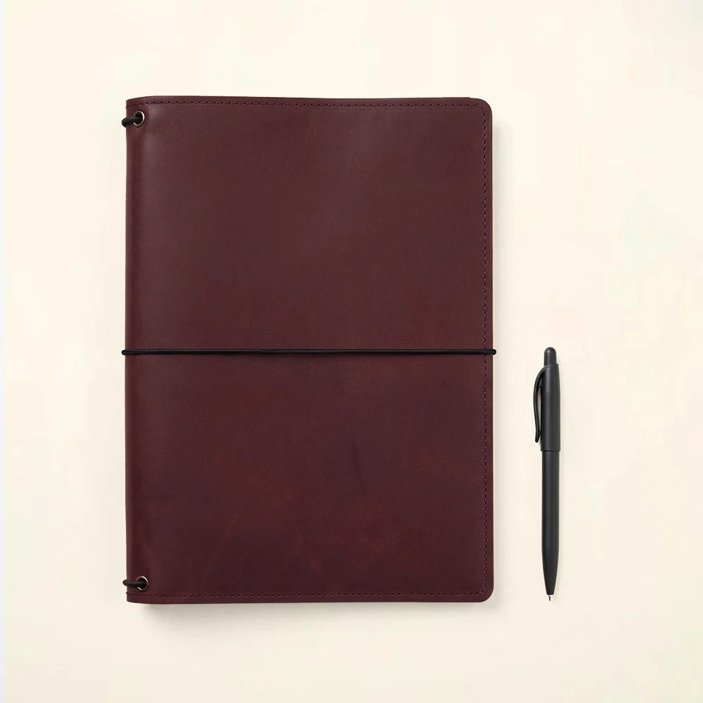 Leather notebook cover crafted with organized pockets and refillable elastic notebook system.