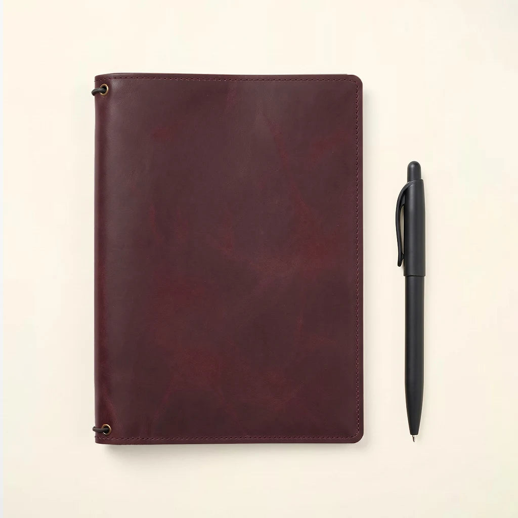 Durable notebook holder with leather construction and elastic notebook support.