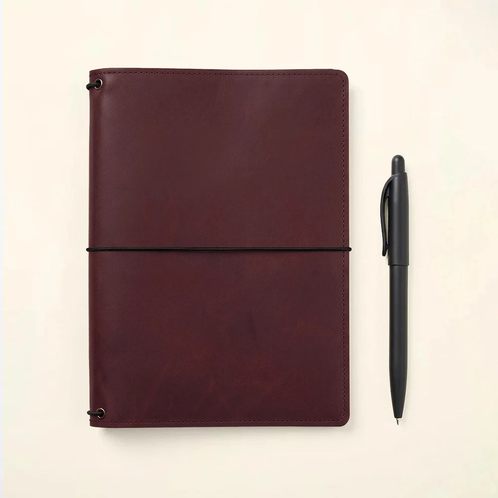 Leather notebook cover featuring handcrafted details and interior organization compartments.