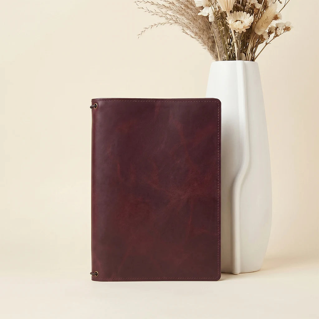 Handmade leather cover with internal pockets and three notebook elastics.