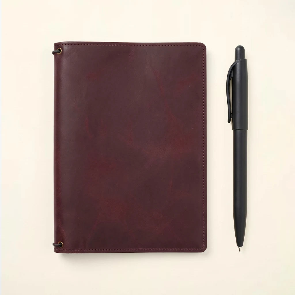 Leather journal holder designed with storage pockets and three elastics.