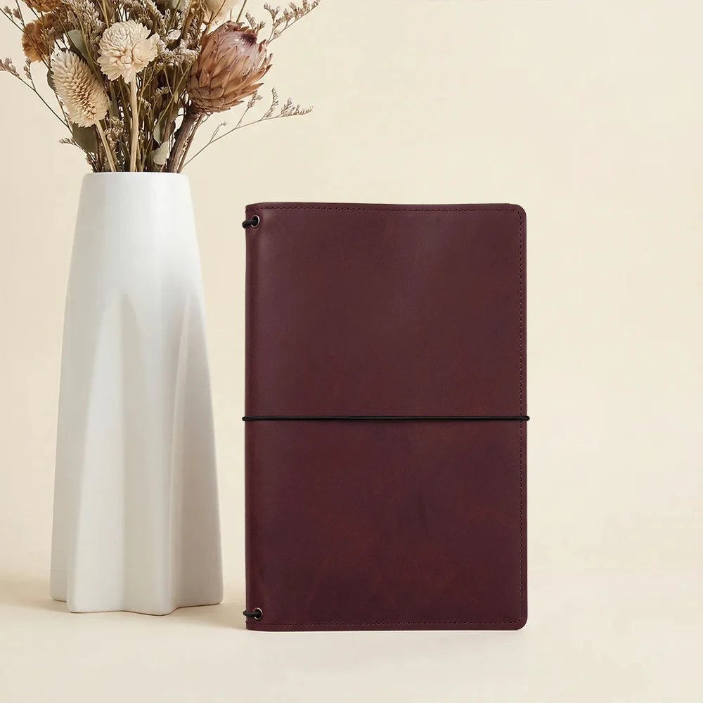 Refillable journal cover crafted from genuine leather with organized pocket design inside.