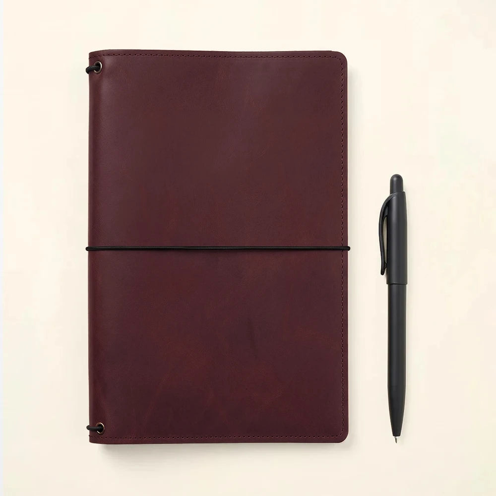 Leather notebook organizer featuring handcrafted construction and spacious interior compartments.