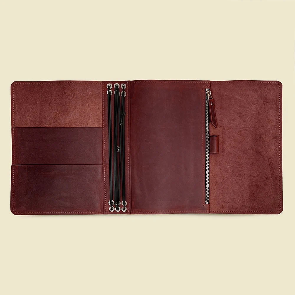 Handmade leather notebook cover with multiple interior pockets and six flexible elastic bands.