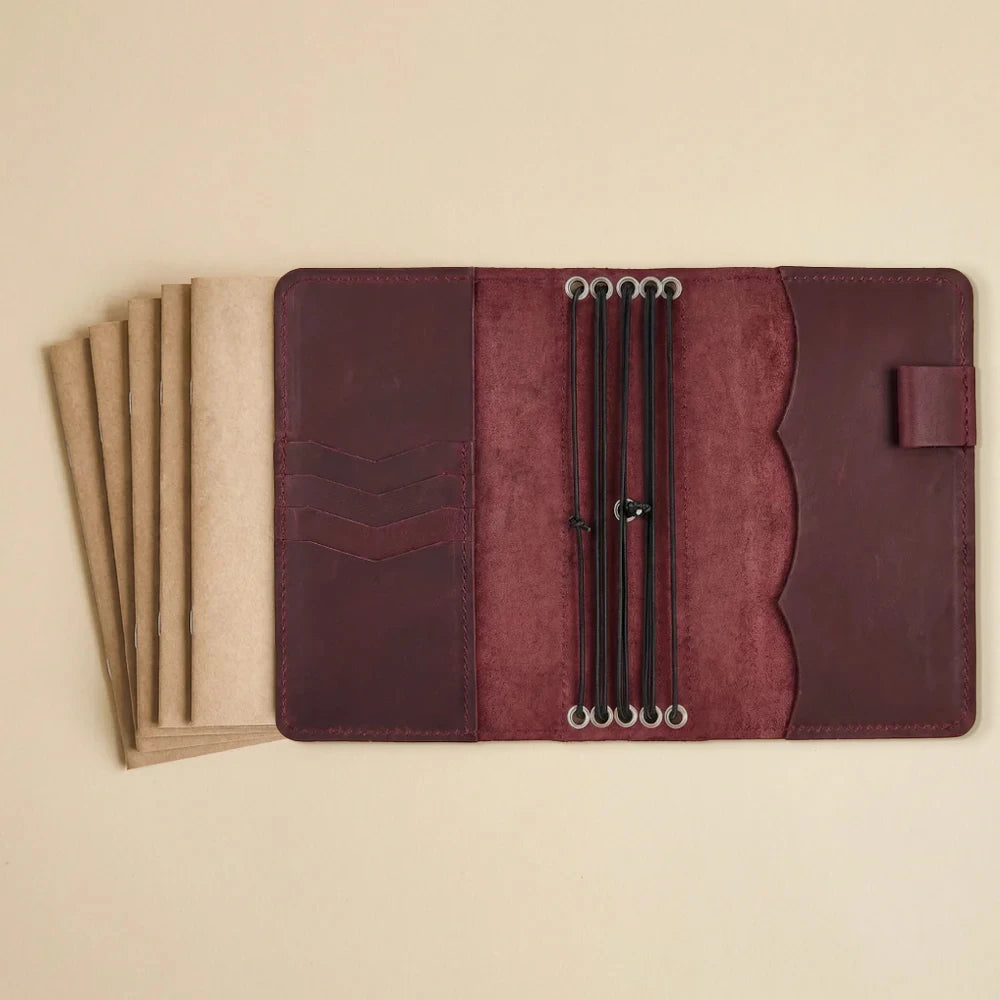 Rustic leather journal cover featuring internal pockets and pen holder.