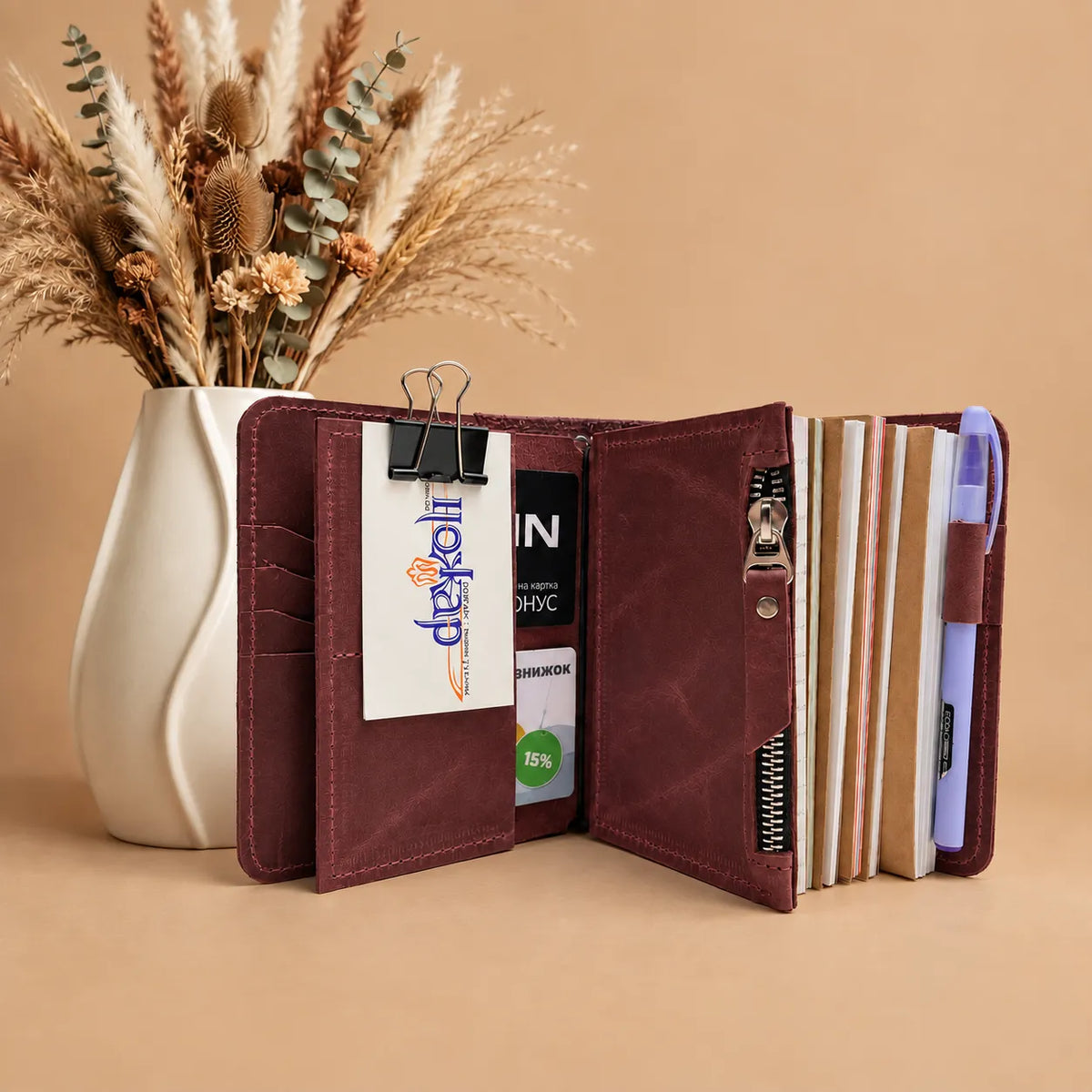 Leather journal cover with five elastic closures and convenient interior pockets.