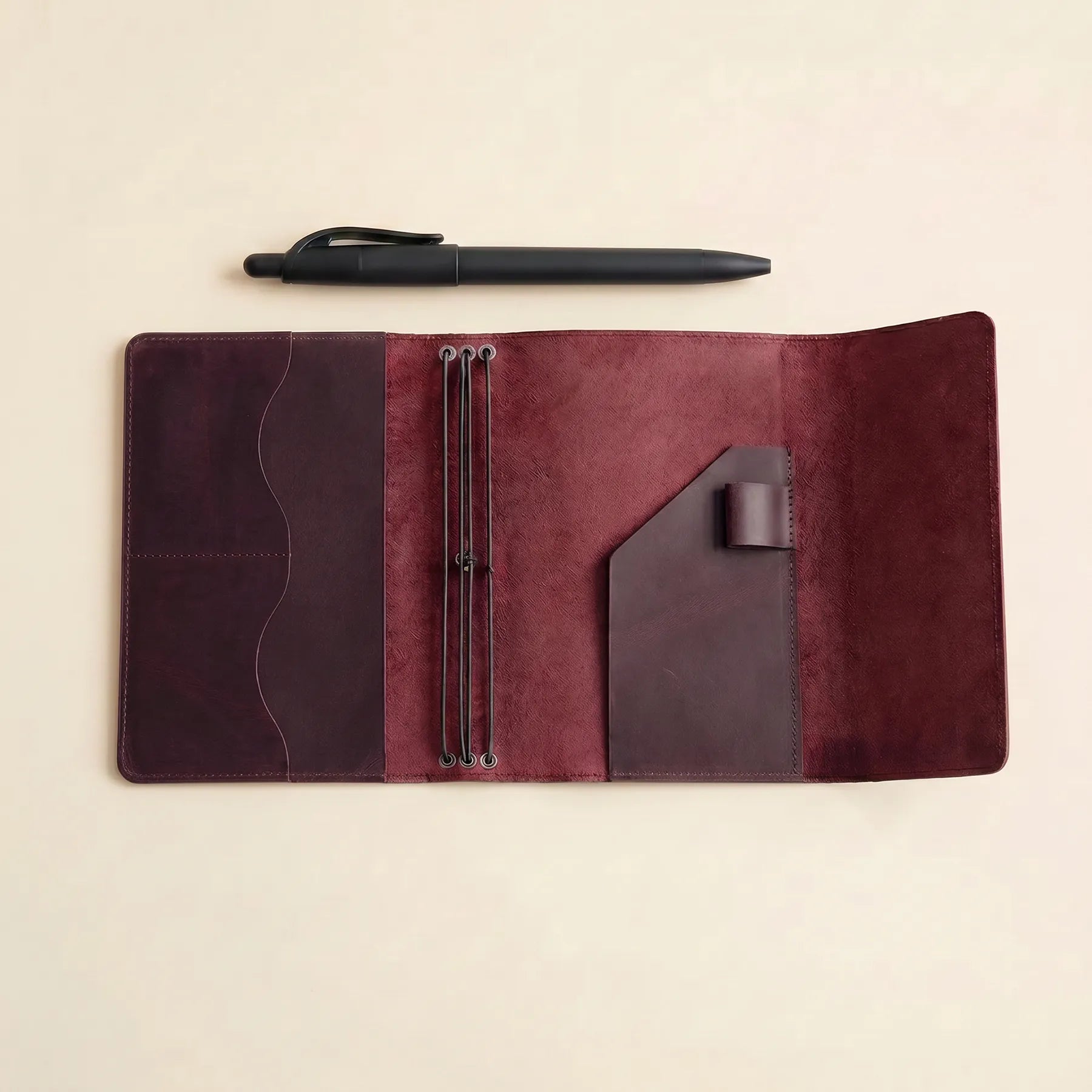 Genuine leather notebook cover with pen loop and practical inner storage.