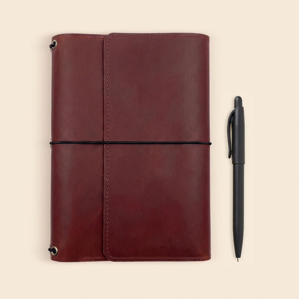 Refillable journal holder crafted from genuine leather with built-in storage pockets.
