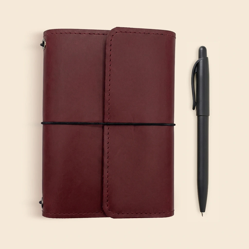 Minimalist leather journal cover designed with elastic notebook inserts and card compartments.