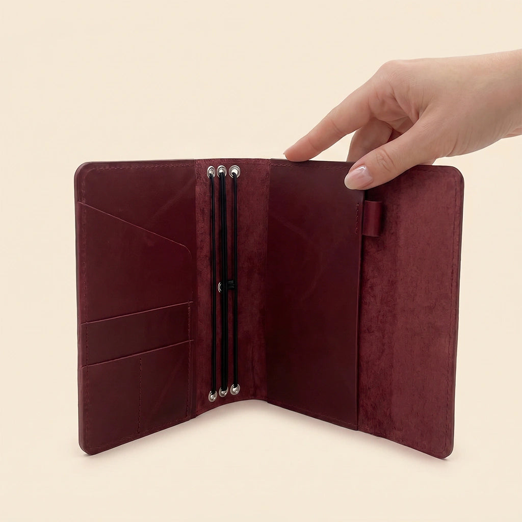 Rustic leather notebook cover with refillable design, card slots, and pen holder.
