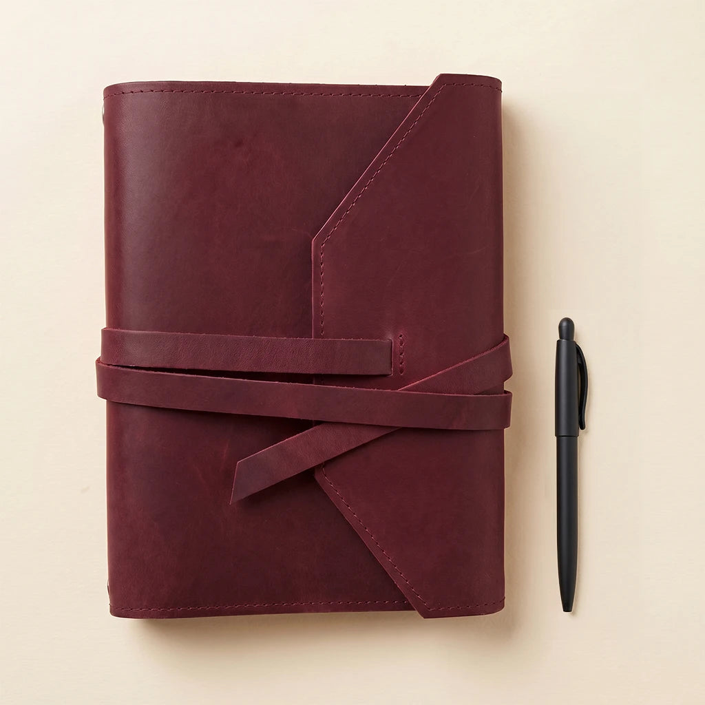 Leather notebook sleeve securing pages neatly with durable elastic bands.