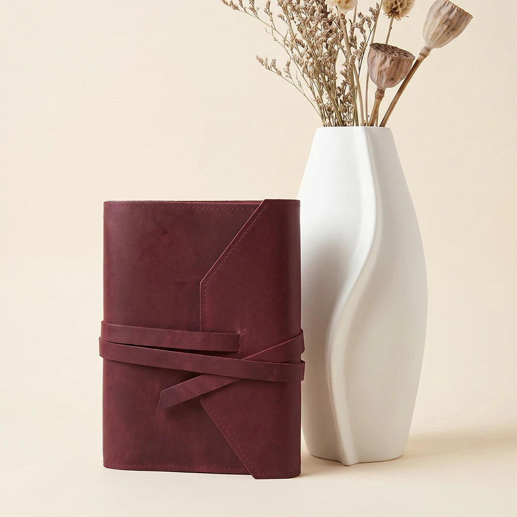 Handmade notebook case with genuine leather finish and practical pen loop.