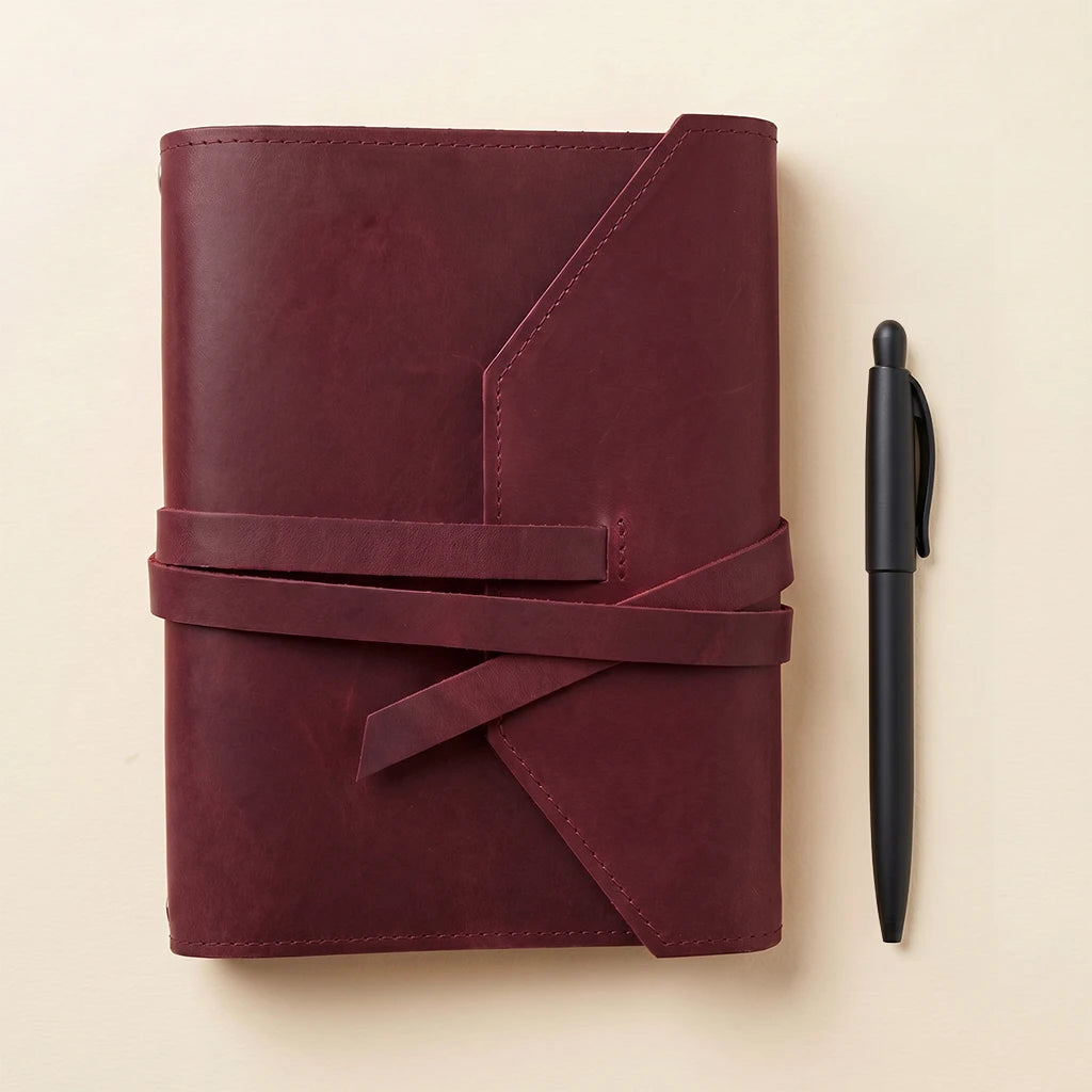Leather notebook protector with secure elastics and loop for favorite writing pen.