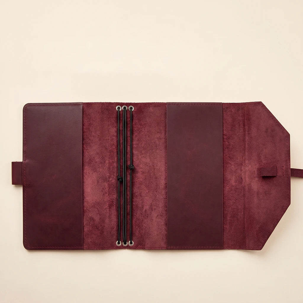 Elegant leather notebook cover with elastic straps and handy pen loop.