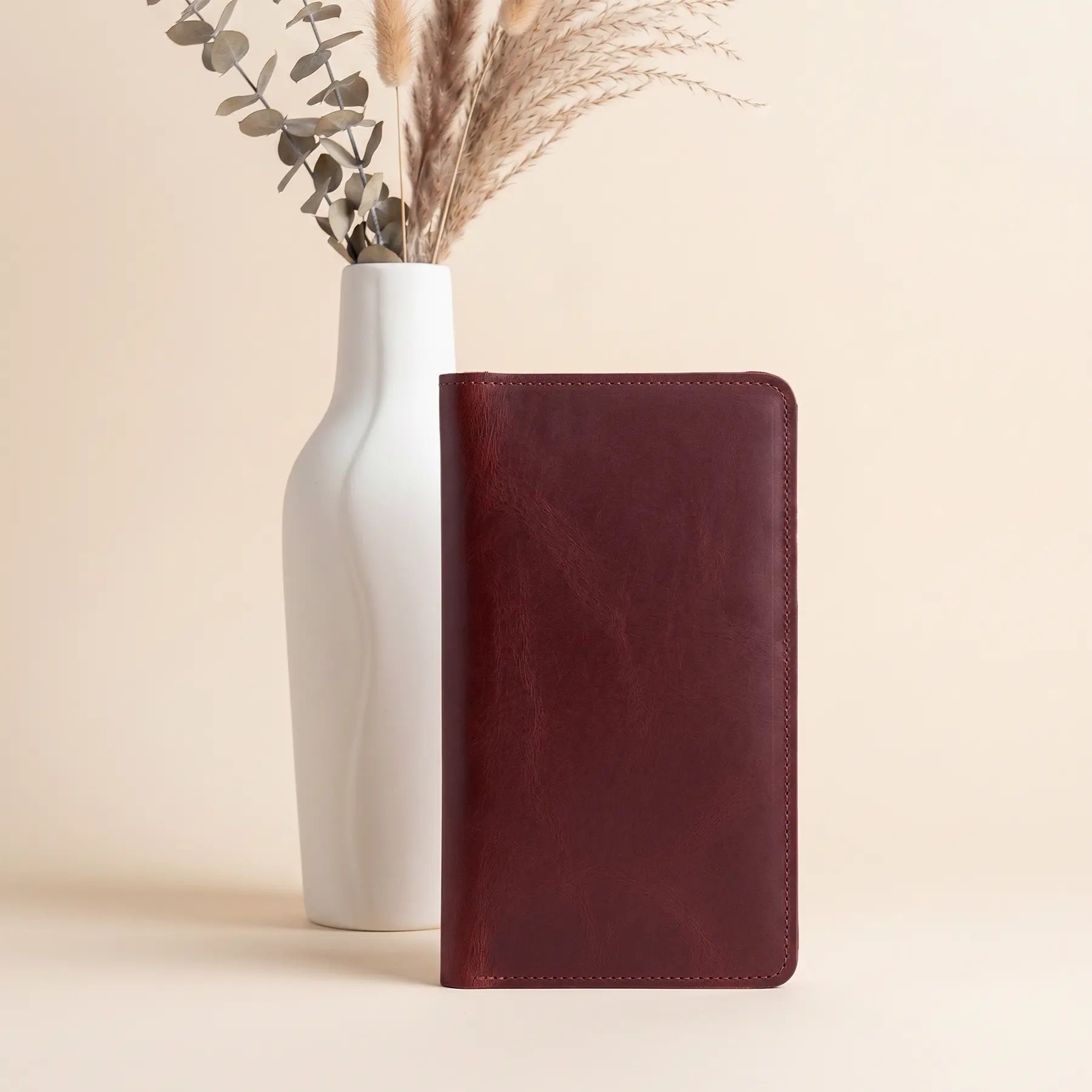 Handcrafted leather long wallet featuring snap buttons, zipper pocket, and organized everyday storage space.