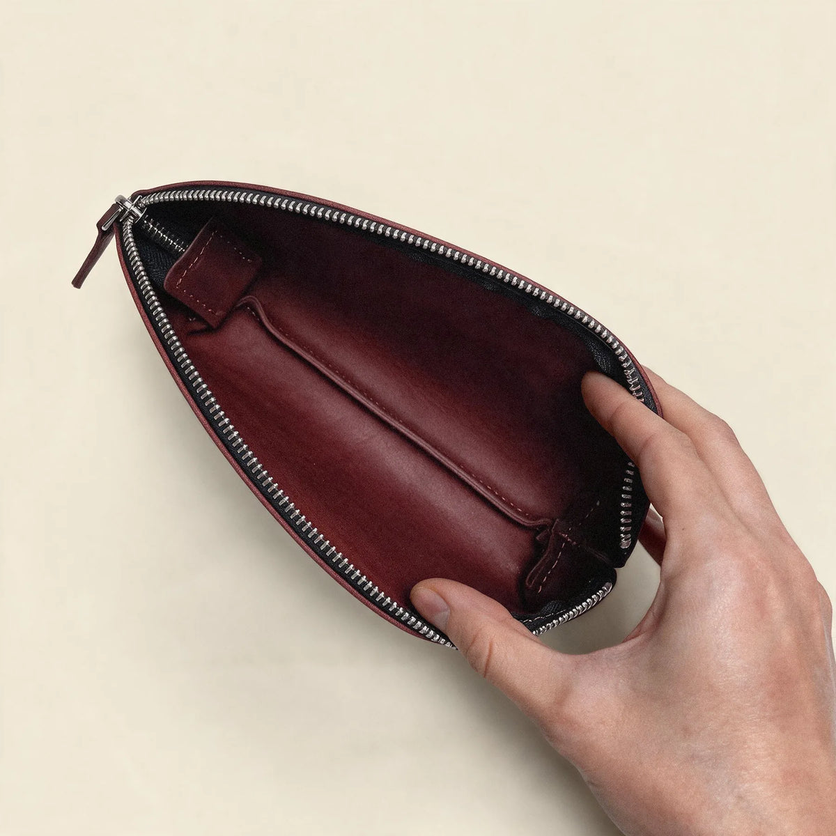 Minimalist leather makeup pouch featuring durable construction and secure zipper closure