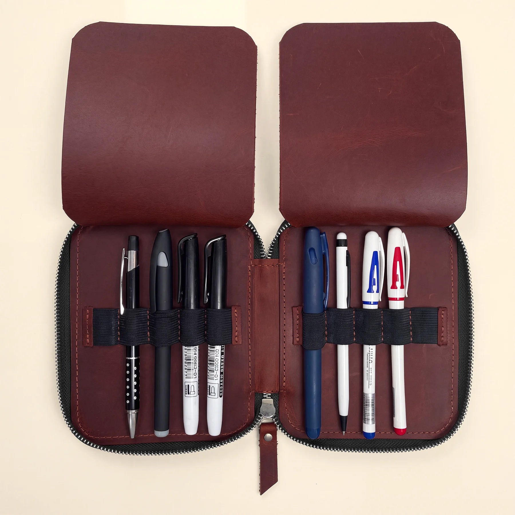 Leather zip pen case designed for organizing fountain pens and writing tools.