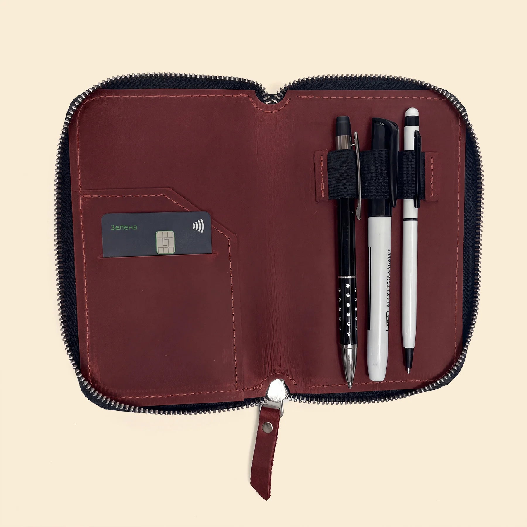 Handmade leather accessory pouch with zipper for pens and office supplies.
