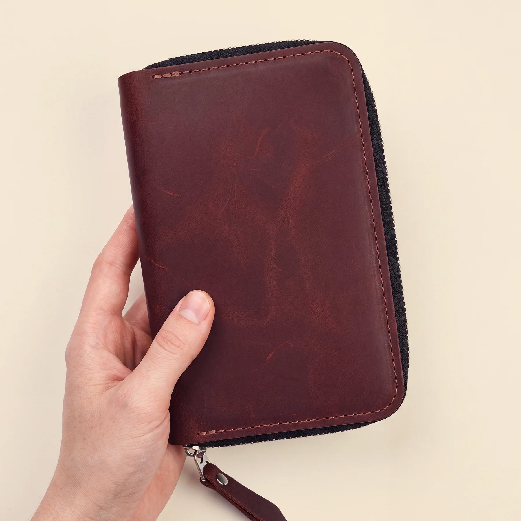 Genuine leather pen organizer with zip closure and elegant handcrafted finish.