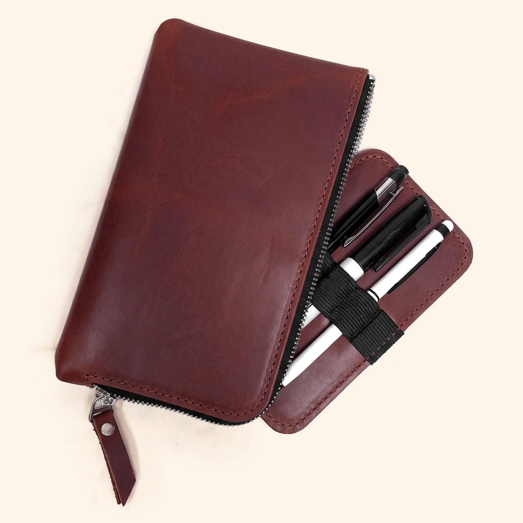 Handcrafted leather pen carrying case with secure zipper and refined appearance.