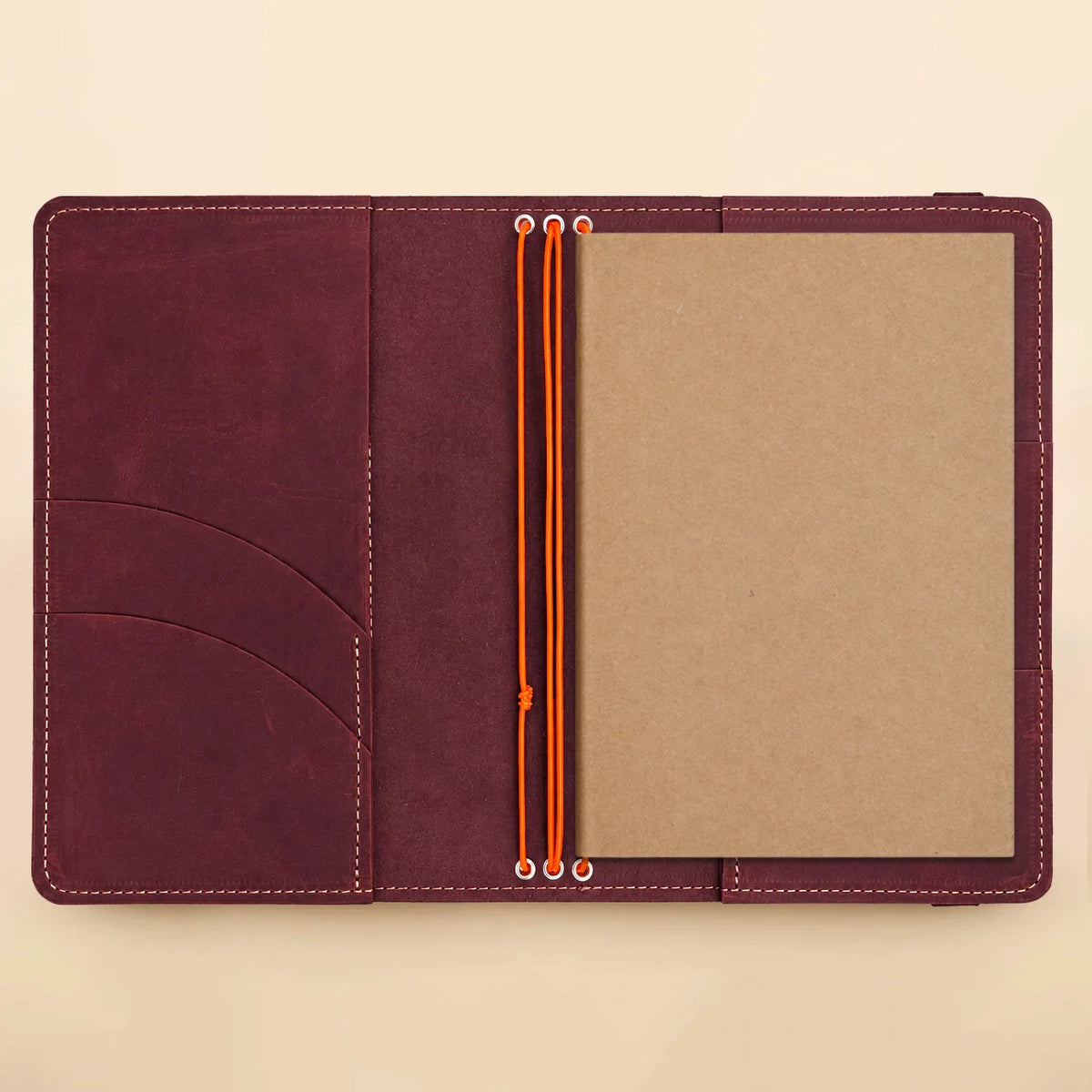 Genuine leather journal organizer with three elastic loops, several pockets, and a clear image insertion window.
