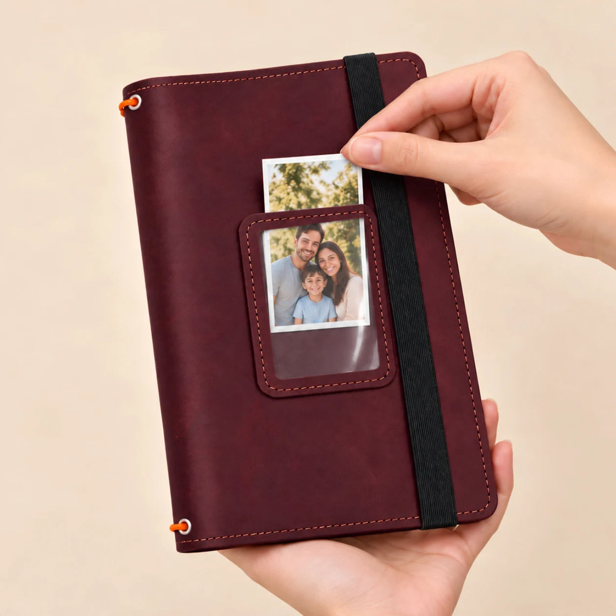 Natural leather notebook featuring three elastic holders, interior storage areas, and a transparent photograph window.