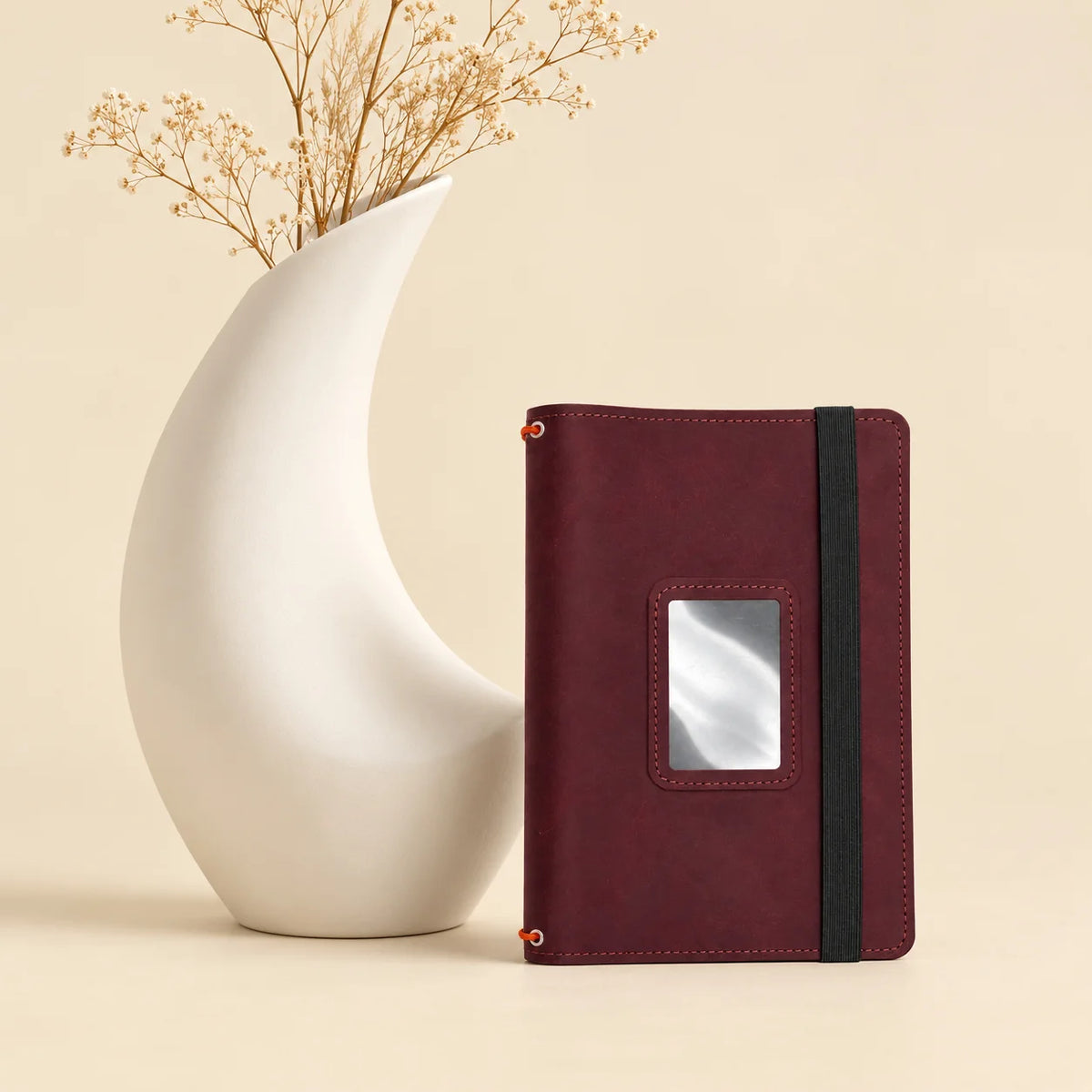 Natural leather journal case with three secure notebook straps and multiple interior compartments.