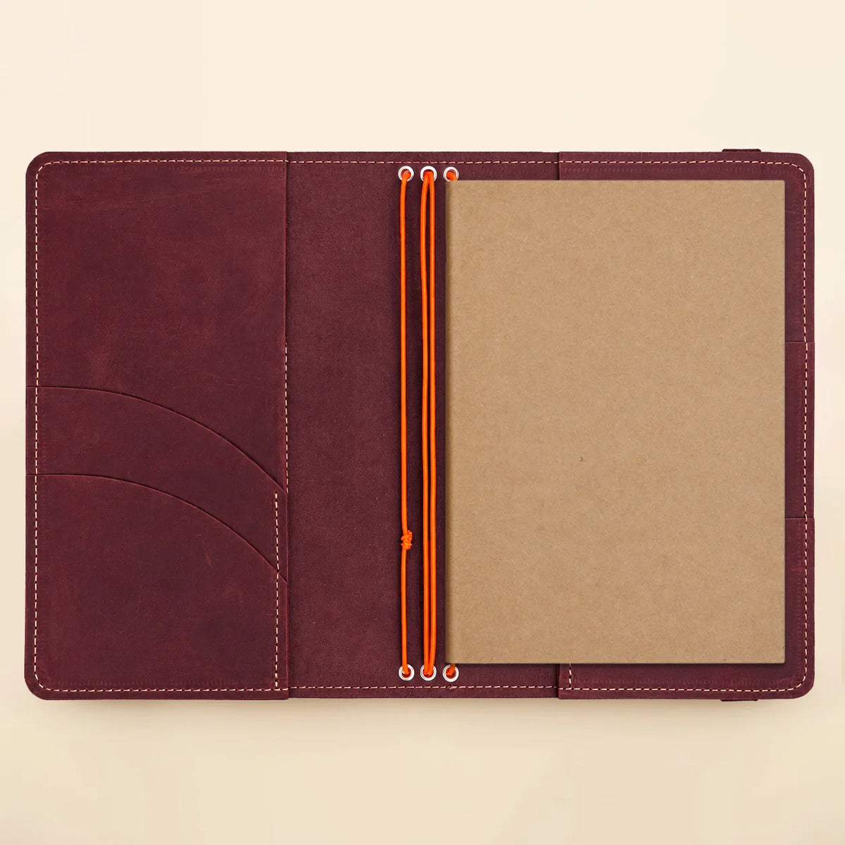 Genuine leather journal organizer with three bands and convenient internal spaces for essentials.