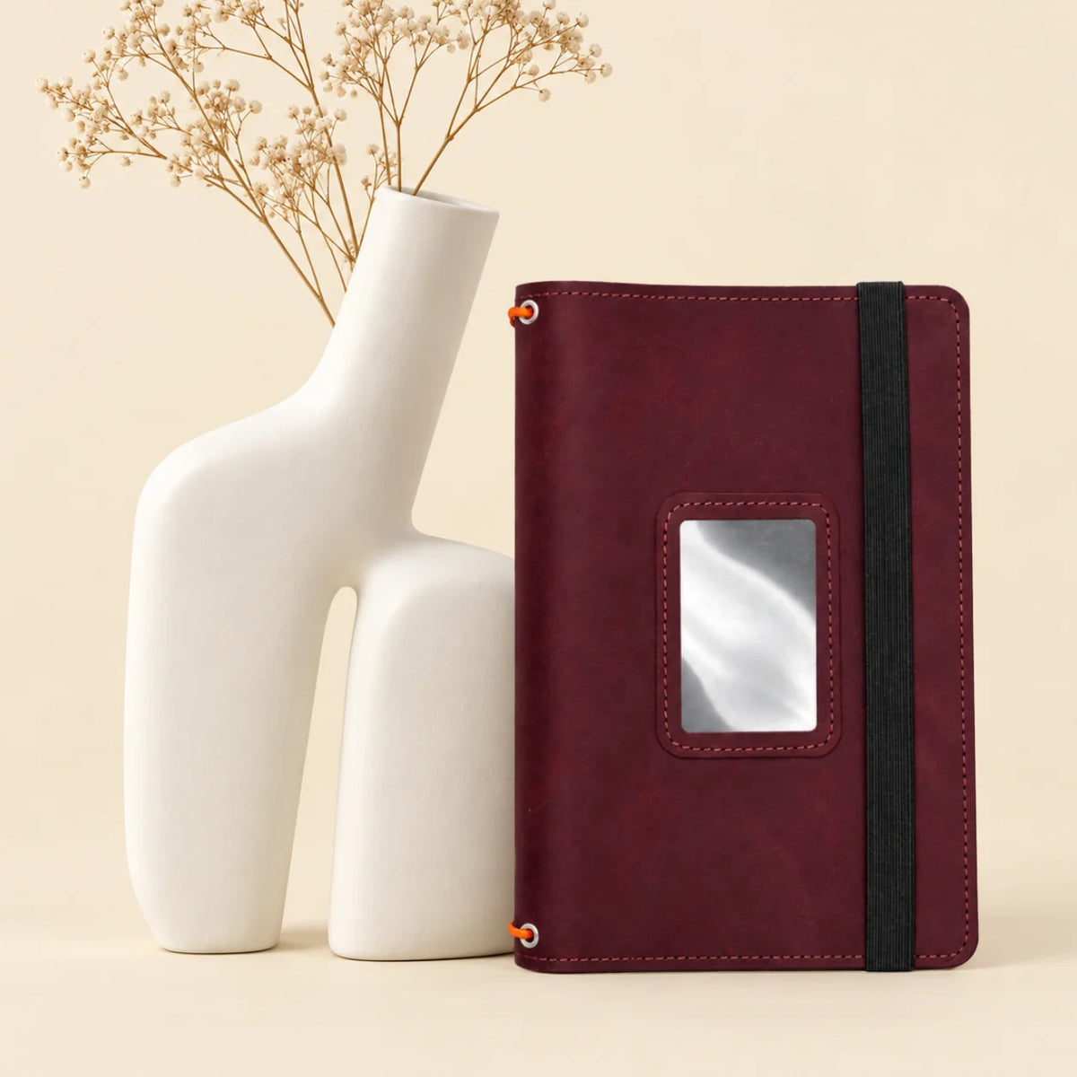 Natural leather notebook case featuring three elastic holders and several built-in interior pockets.